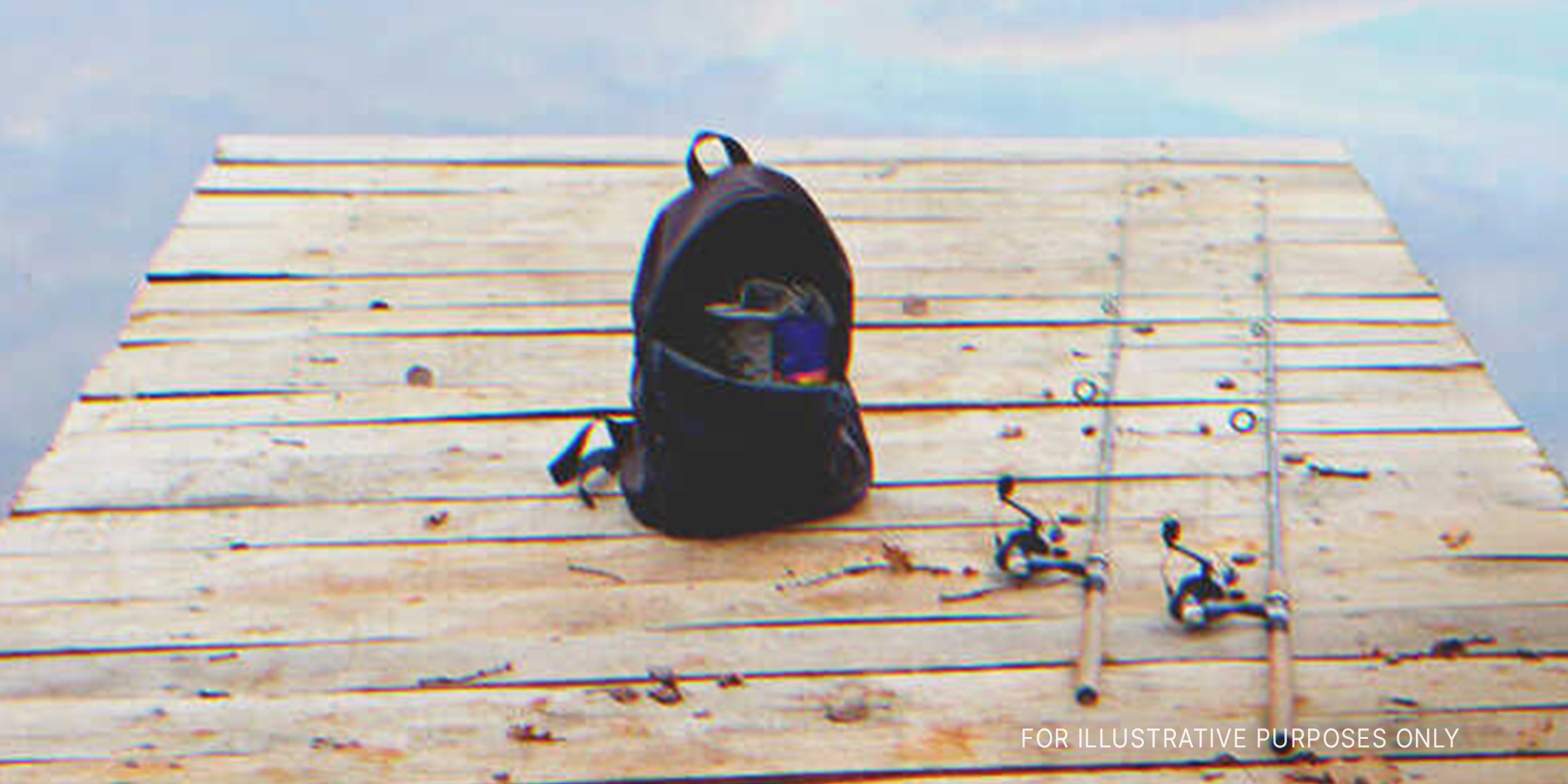 Fishing Rods And Backpack On Wooden Plank. | Source: Shutterstock
