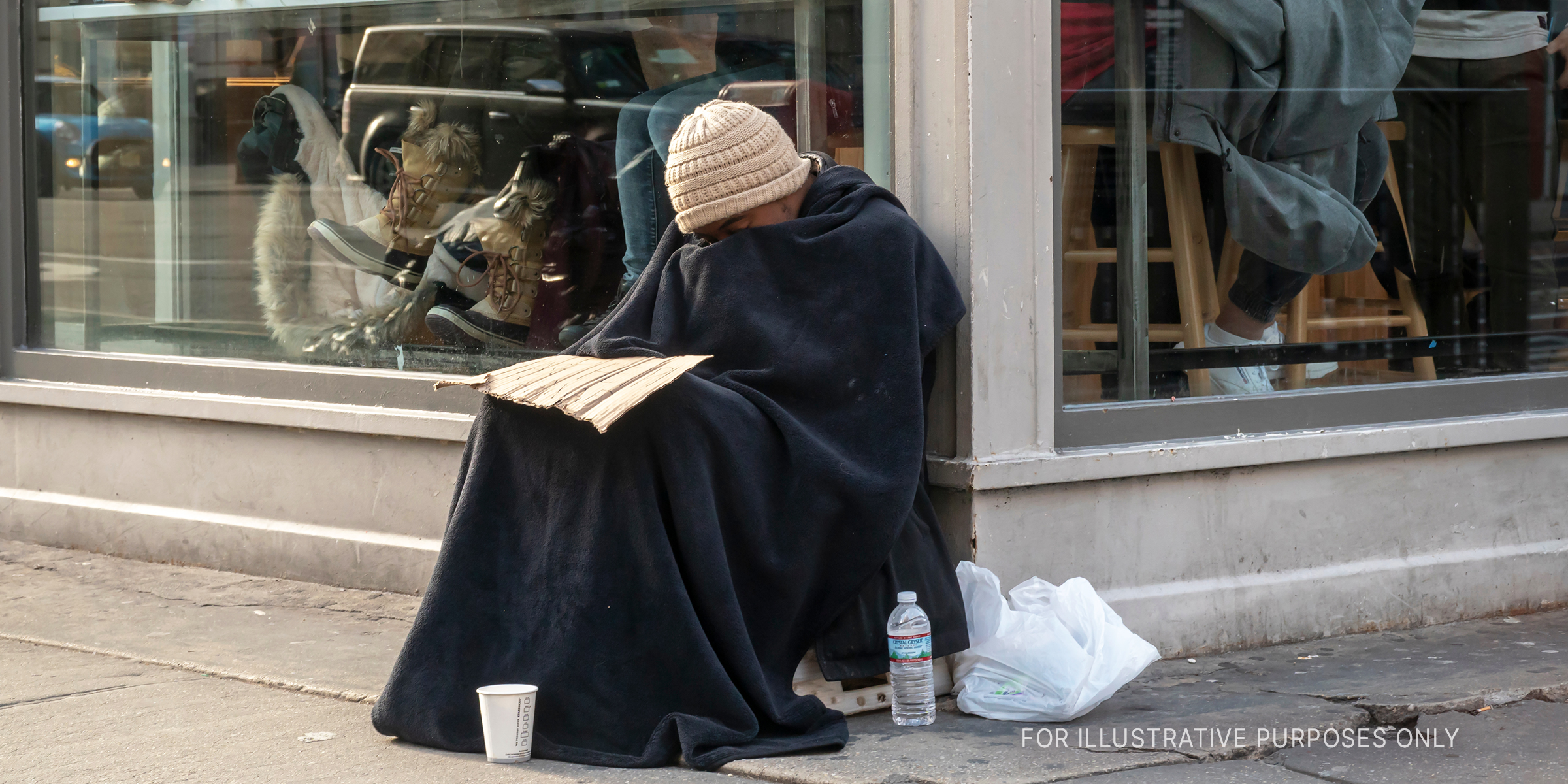 Homeless man sitting outside a restaurant | Source: Shutterstock