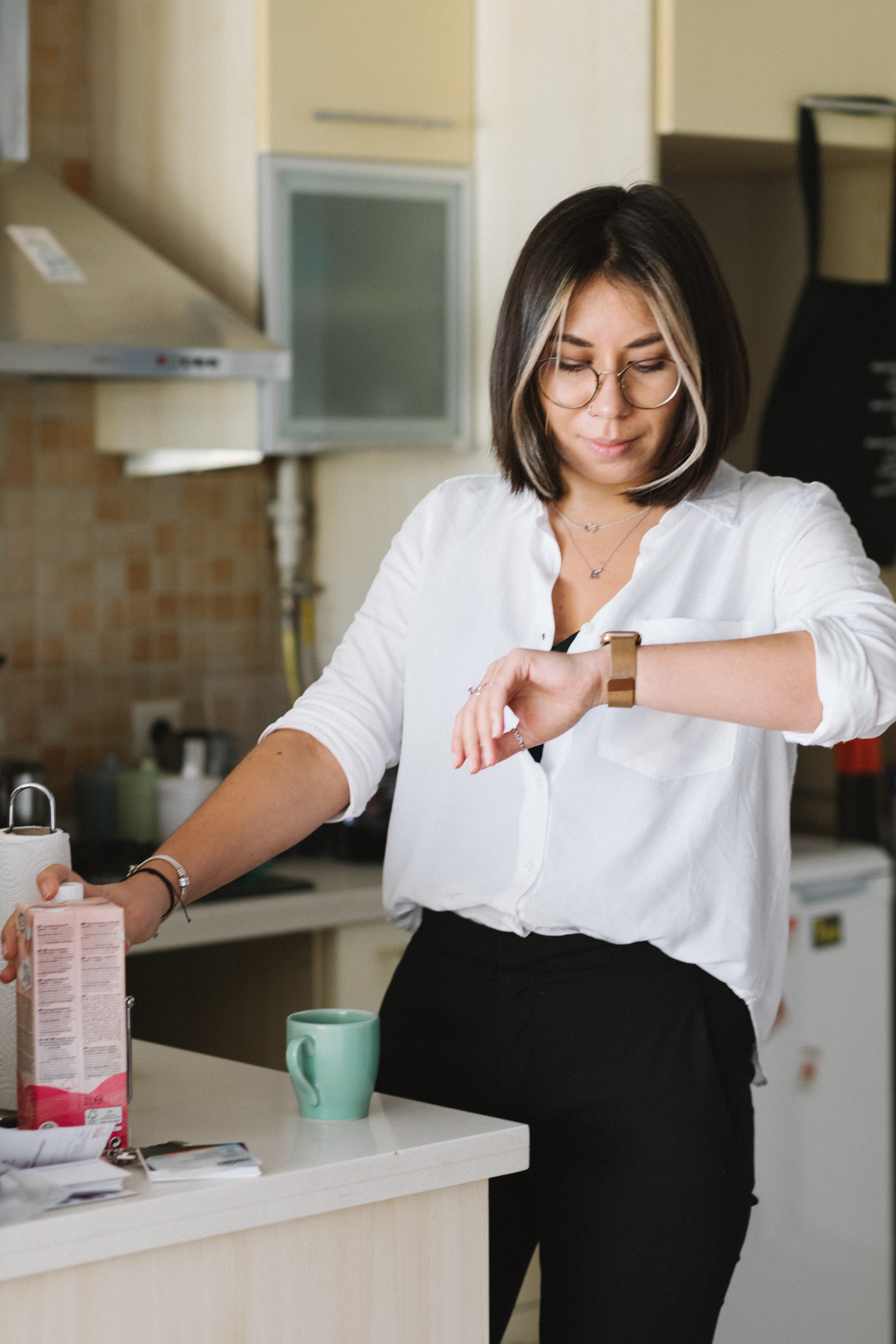 A woman looking at her watch. | Source: Pexels