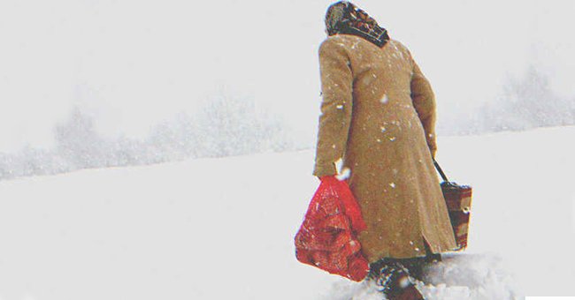 An old lady walking in the snow | Source: Shutterstock