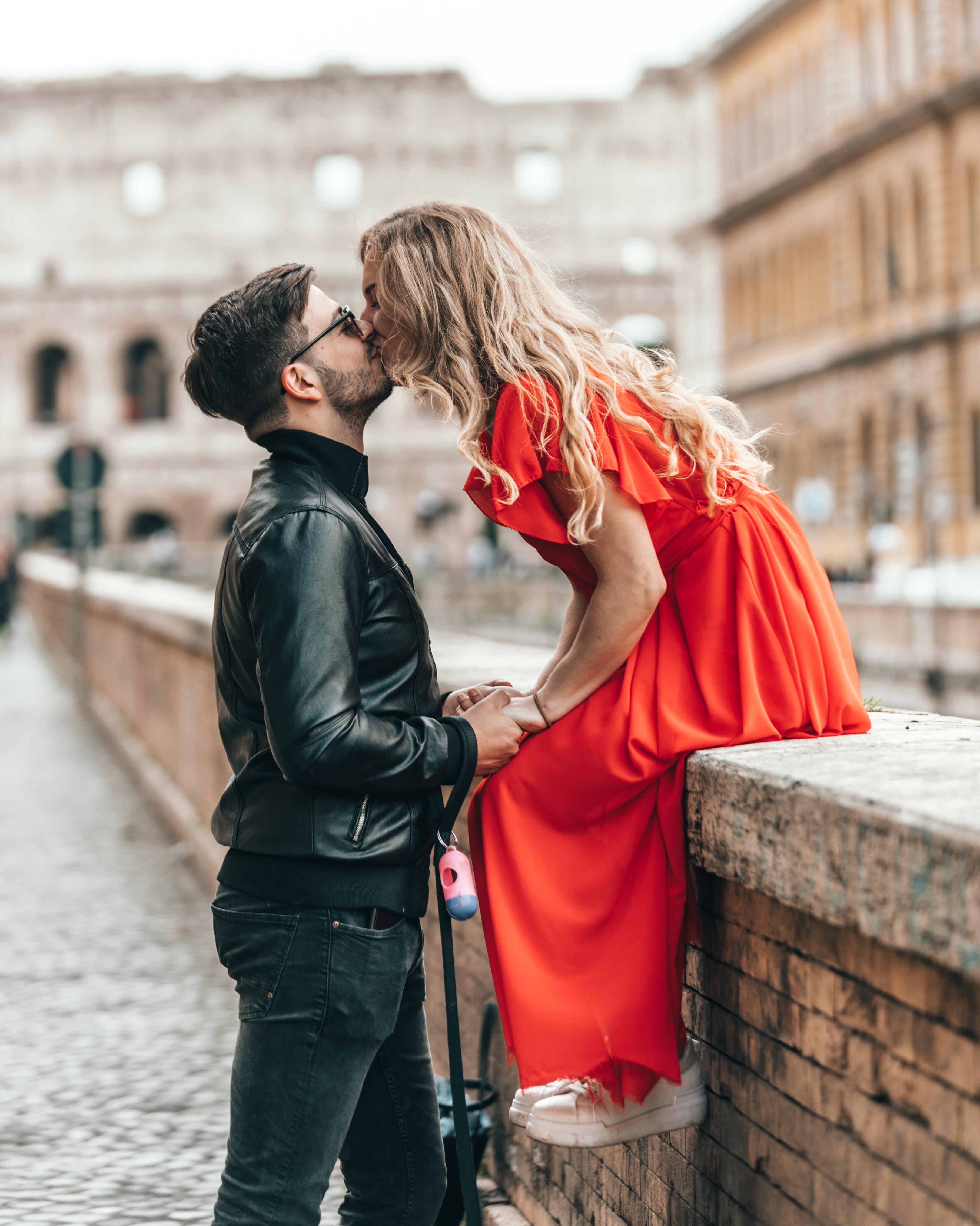 A photo of a man and a woman kissing outdoors  | Source: Unsplash