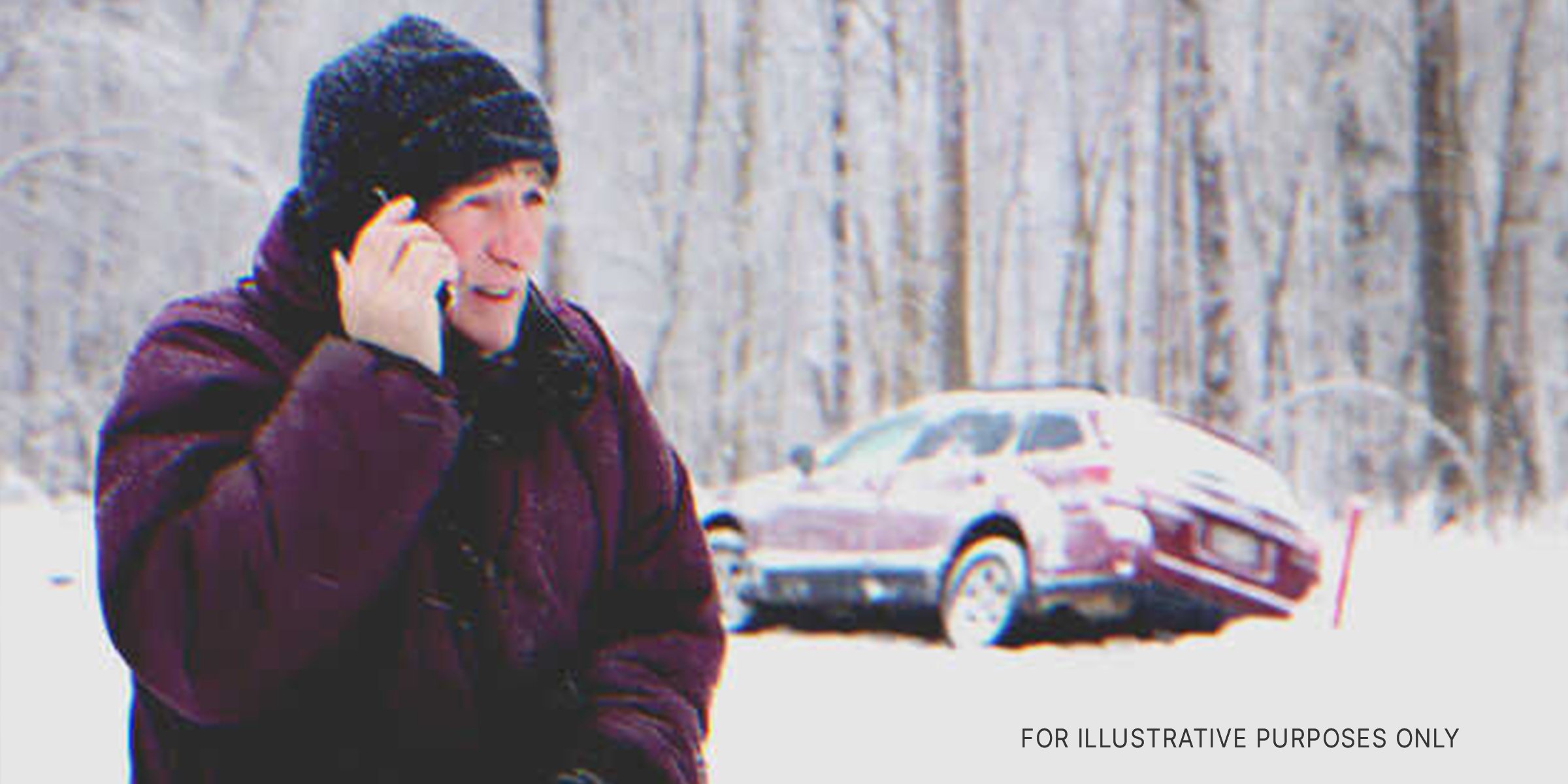 Getty Images | Man holding a cellphone on a snowy road.