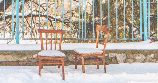 Two chairs covered in snow | Source: Shutterstock
