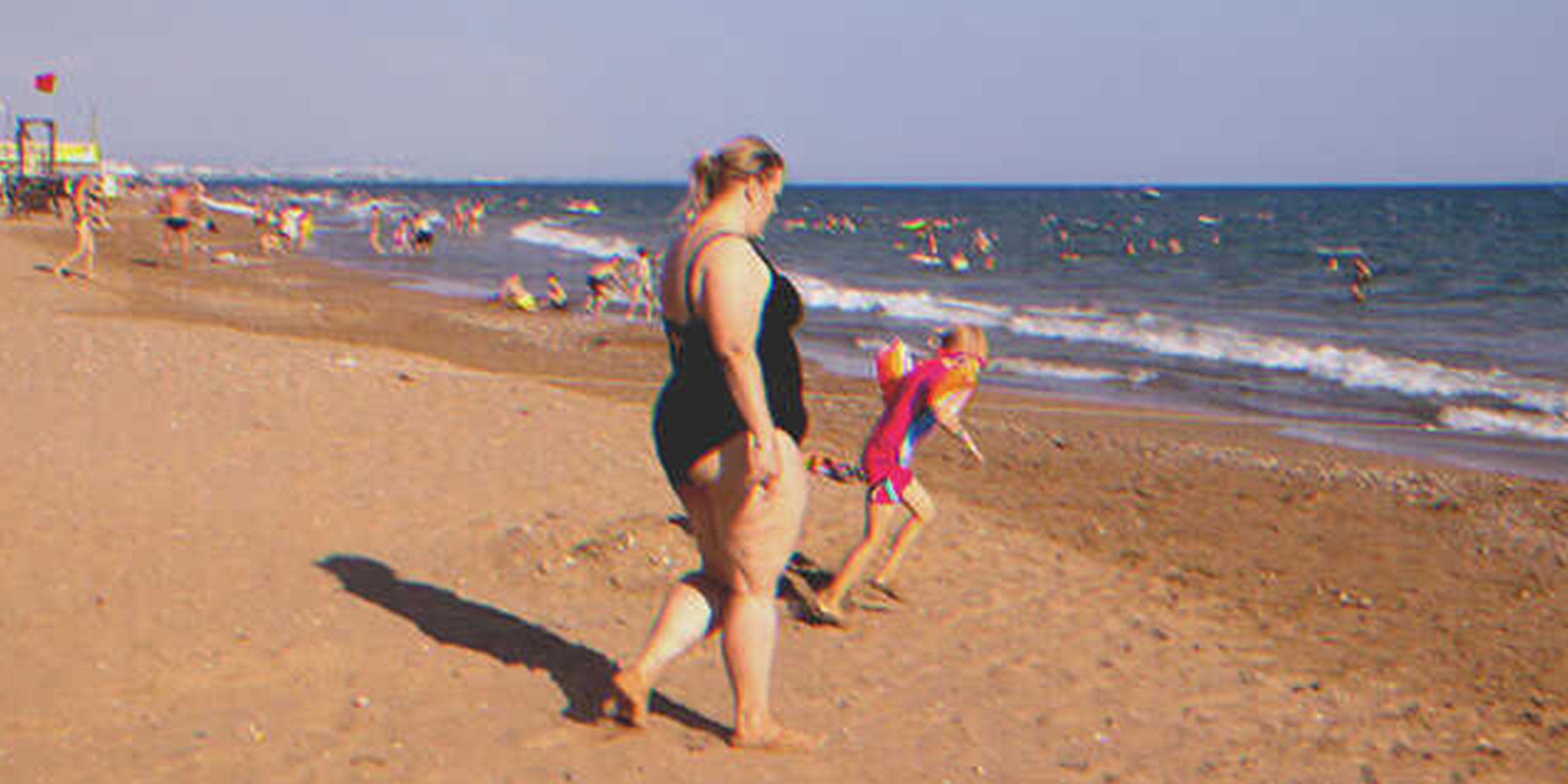 Plump woman on beach | Source: Shutterstock