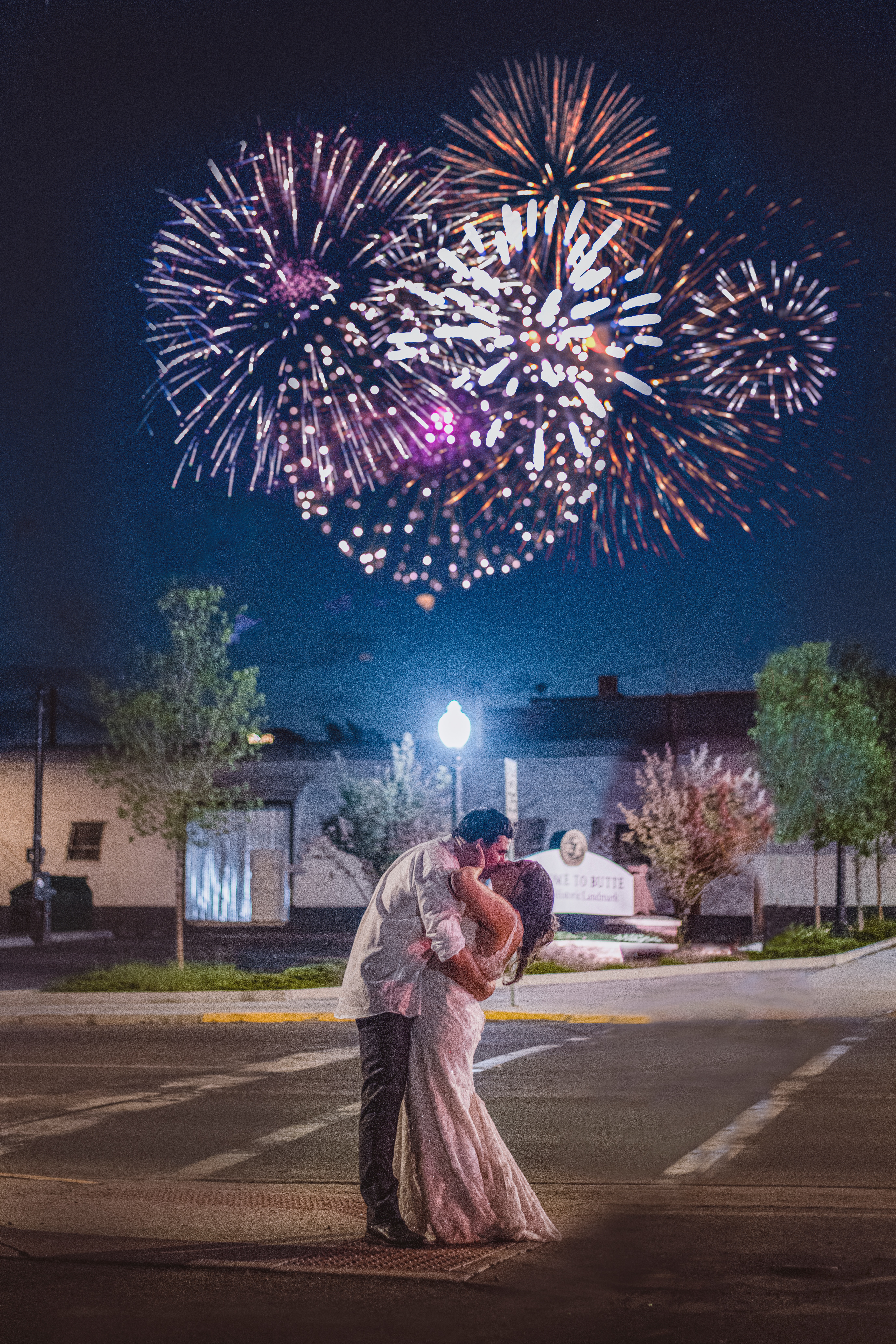 A couple kissing in the street with fireworks in the background. | Source: Unsplash