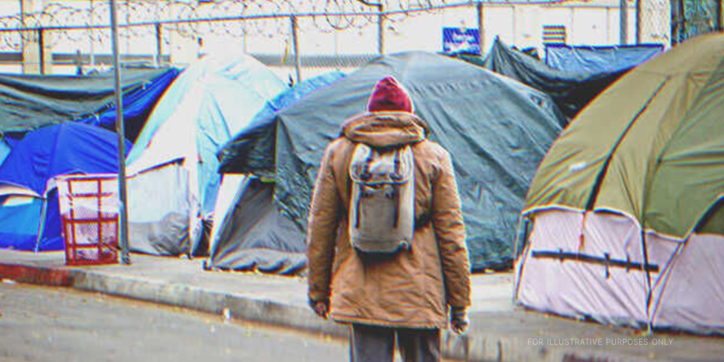 Man in front of tents. | Source: Shutterstock