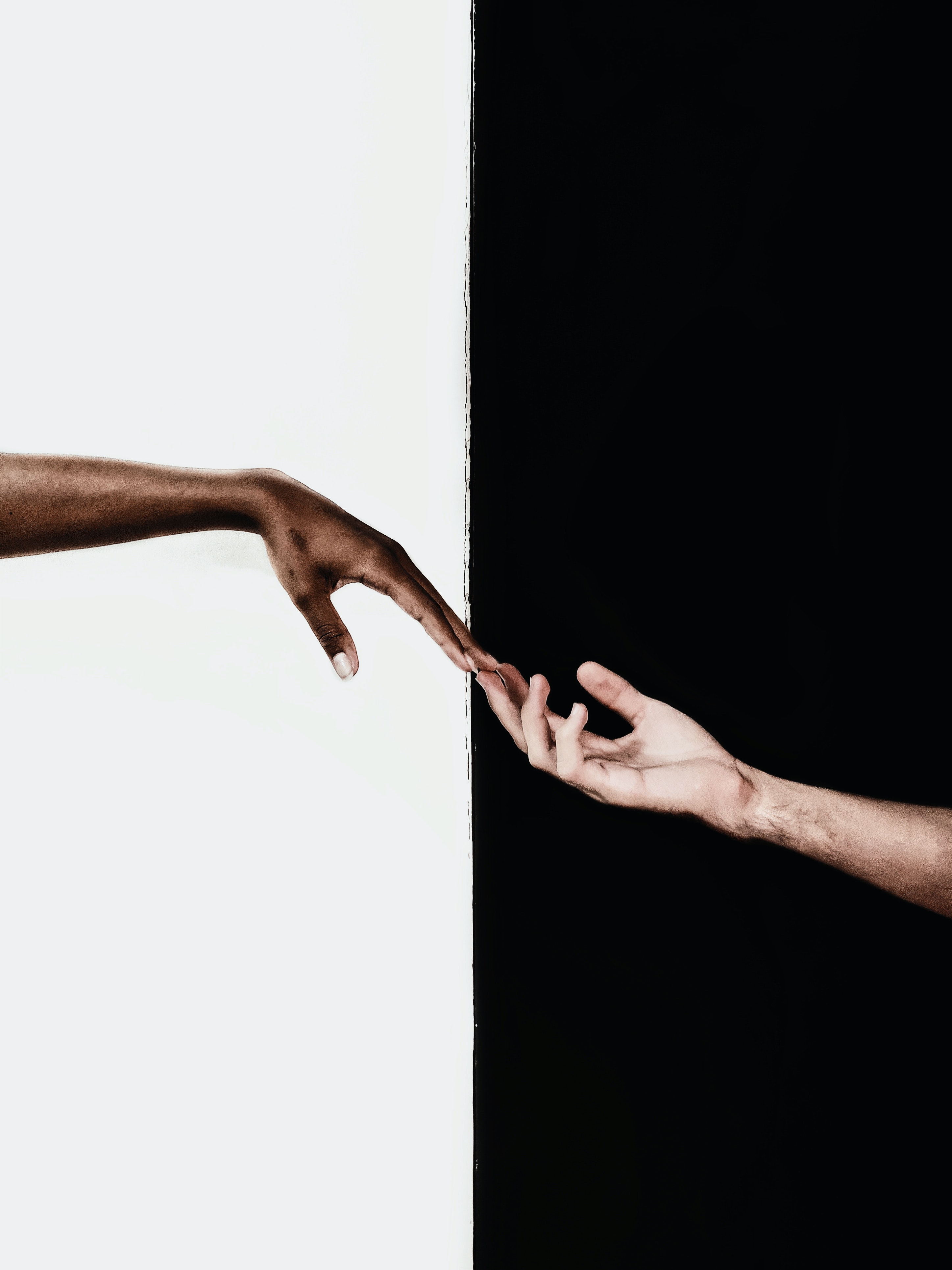 Two individuals touching fingers. | Source: Pexels