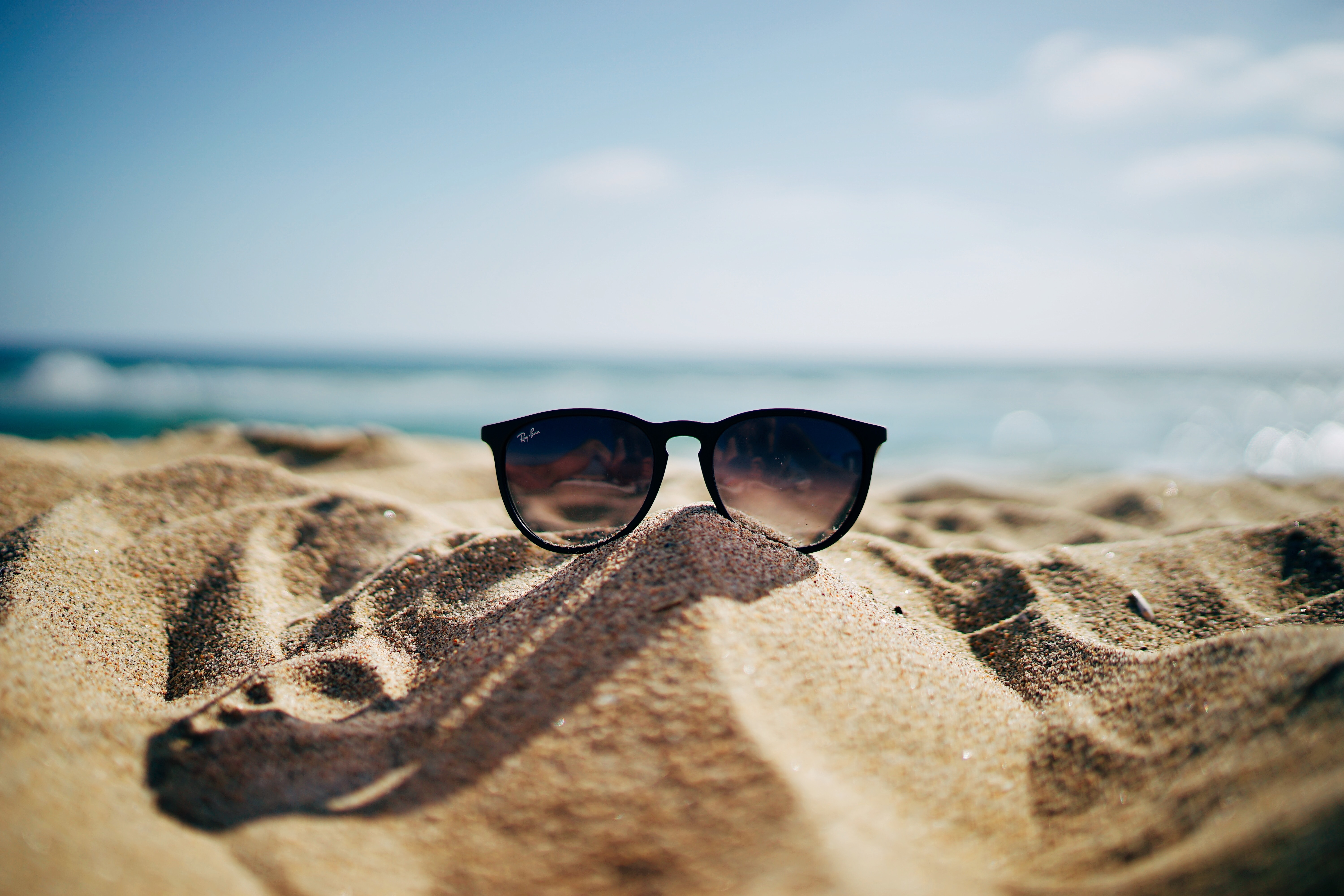 Sunglasses on the beach. │ Source: Unsplash